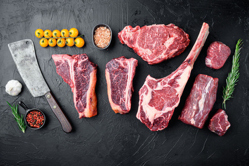 tagAlt.Various cuts of marbled beef meat and dry aged steaks, tomahawk, t bone, club steak, rib eye and tenderloin cuts, on black ston