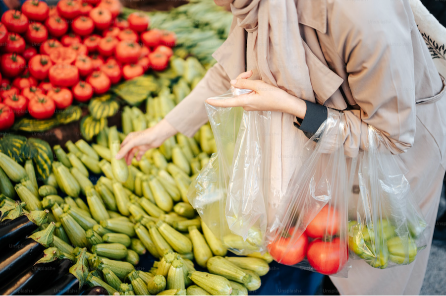 a woman selecting vegetables at a market
