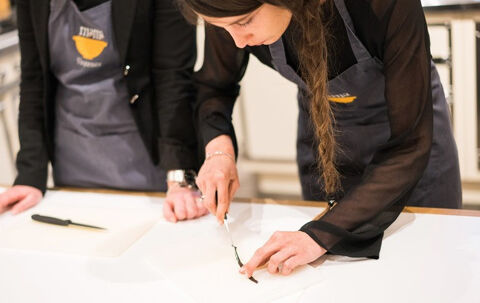 a girl cutting on a table very precisely