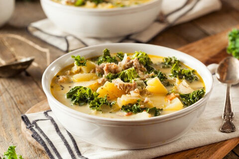 a soup of potatoes beef and kale