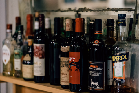 selection of liquor bottles lined up behind a bar
