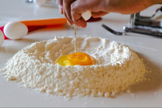 breaking egg into flour