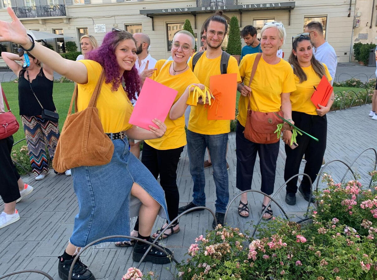 group of mama florence tour guides smiling and posing with guide materials