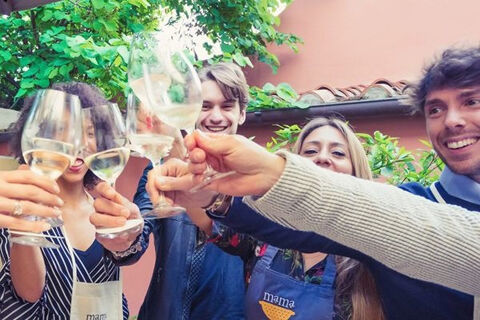 group cheers with wine glasses outside