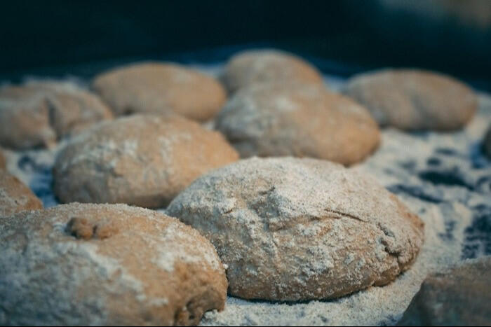 raw pizza dough dusted with flour.