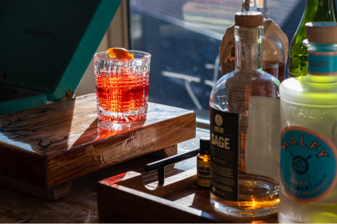 negroni cocktail in a bar with liquor bottles