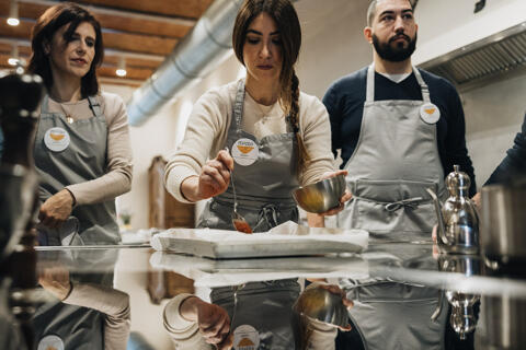cooking class student prepares food in kitchen