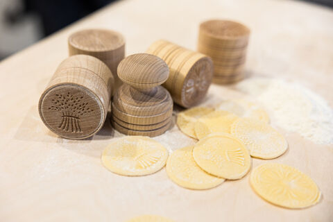 wooden corzetti stamps with example pasta