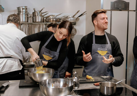 couple in cooking class smiling