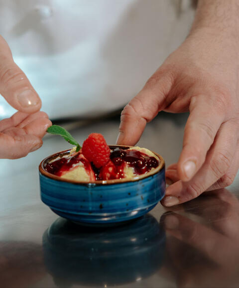 cream gelato with berry sauce