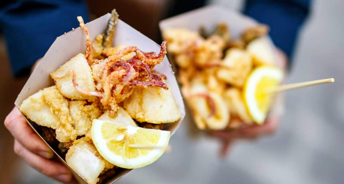 mixed fried seafood in a paper cone with lemon