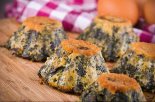 spinach flan served on a wooden board