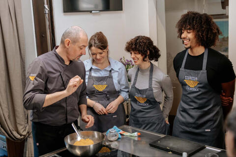 chef explaining to students in cooking class