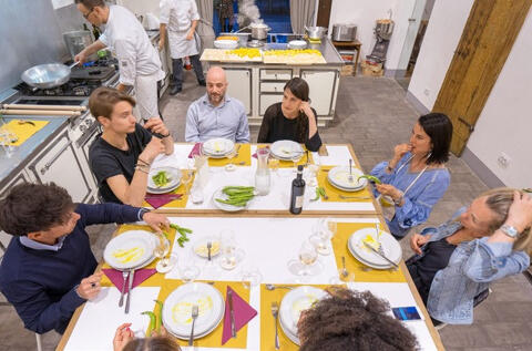 group sat at table eating a meal