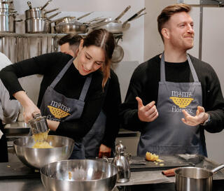 couple cooking during mama florence cooking class