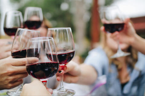 Group cheers with red wine