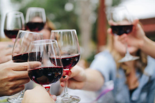 Group cheers with red wine