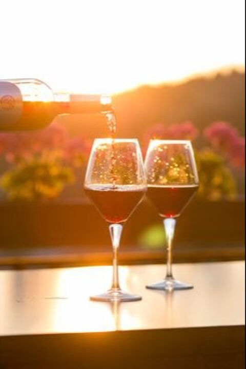 red wine and two wine glasses with tuscan sunset