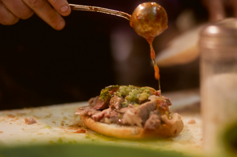 lampredotto being served with sauce