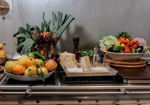 gullo kitchen with fruit, vegetable and cheese displayed