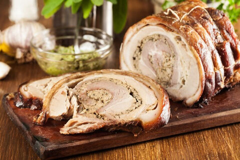 pork roulade sliced on a wooden board