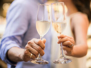 couple holding flutes of champagne