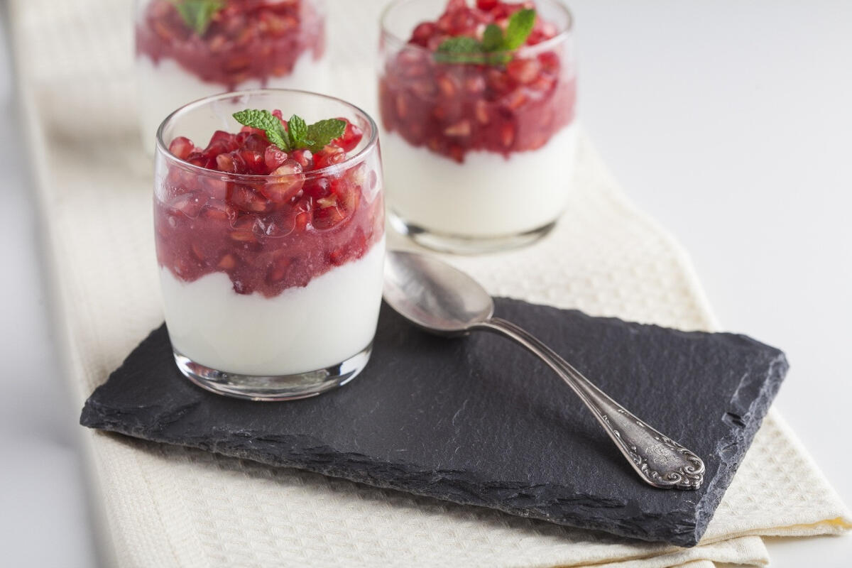 yogurt mousse with strawberry topping served in glasses on a slate board