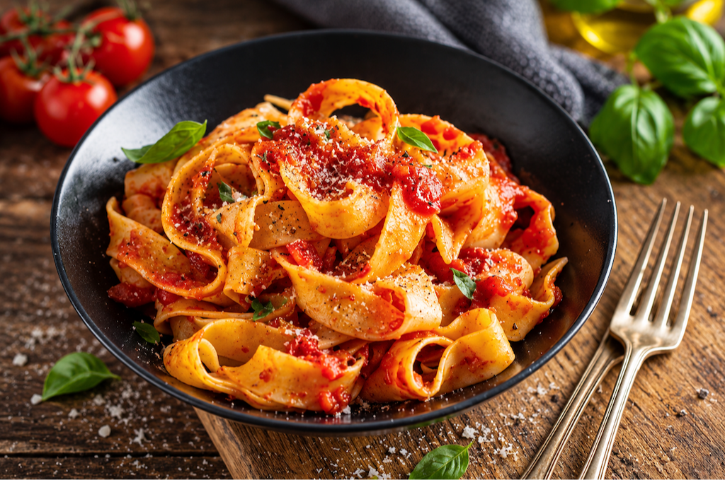 pappardelle pasta served with vegetarian ragu sauce and basil