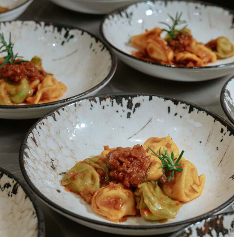colored tortelli with meat ragu