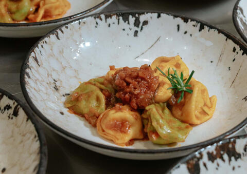 tortelli pasta served with meat ragu