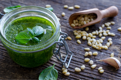 fresh pesto in glass jar with pine nuts