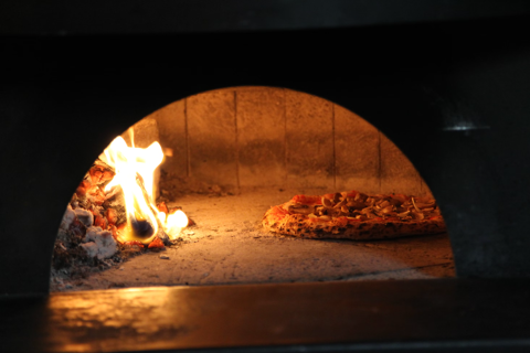 pizza inside wood fired oven