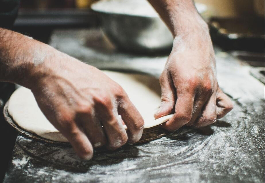 chefs hands making pizza dough