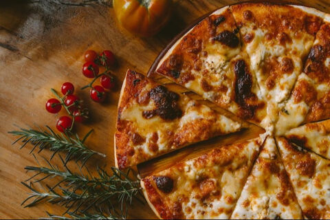 Margherita pizza on wooden table.