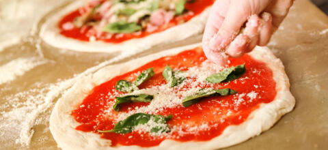 fresh pizzas prepared with tomato basil and parmesan