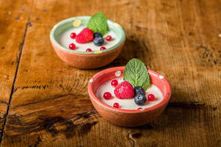 two small bowls of panna cotta with berries.