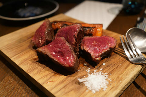 rare steak served on wooden board with salt