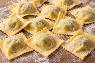 ravioli served with rosemary sauce in a bowl