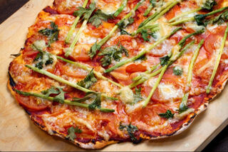 pizza with green herbs cheese and tomato