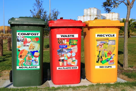 three coloured recycling waste bins