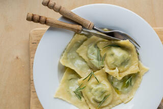 ravioli served with rosemary sauce in a bowl