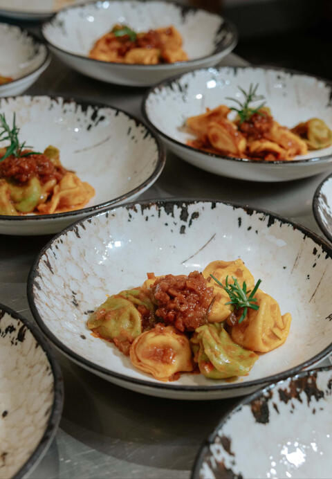 tortelli with ragu in bowl