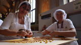 two women making tortellini