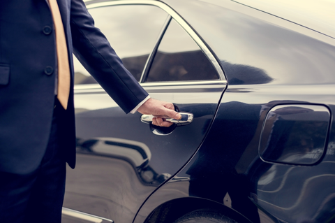 private chauffeur opening car door