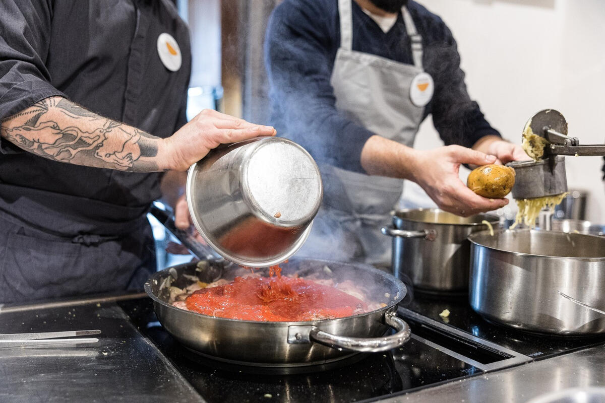 chef and student preparing food in cooking class