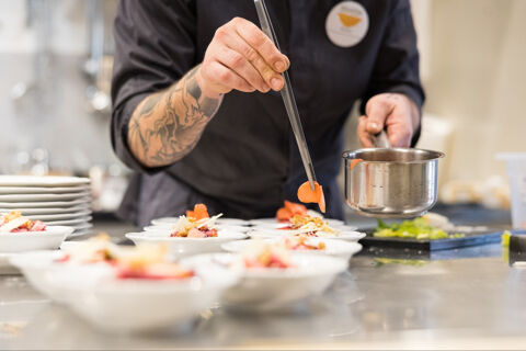 chef decorating plates of food