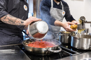 Chef and student cooking in Tuscan cooking class