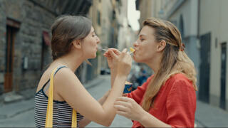 two women sharing gelato