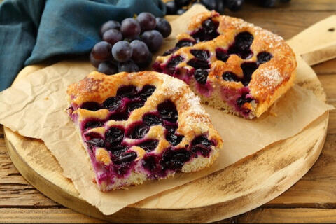 grape bread sliced and served on a wooden board