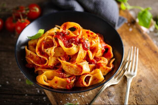 pappardelle pasta served with tomato sauce and basil